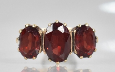 A 9ct Gold and Garnet Dress Ring, Central Oval Cut Stone Mea...