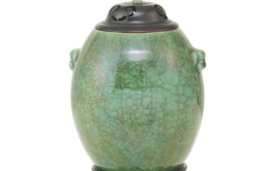 A CHINESE APPLE-GREEN GLAZED JAR WITH HARDWOOD LID AND STAND Qing Dynasty (1644-1912), 18th /19th Century