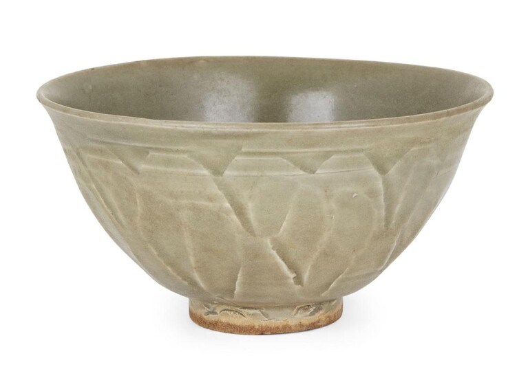 A Chinese Yaozhou celadon-glazed carved 'lotus petal' bowl, Northern Song dynasty, the exterior of the bowl carved with overlapping upright lotus petals, covered in an olive-green glaze, 13.8cm diameter c.f. A similar Yaozhou bowl was sold at...