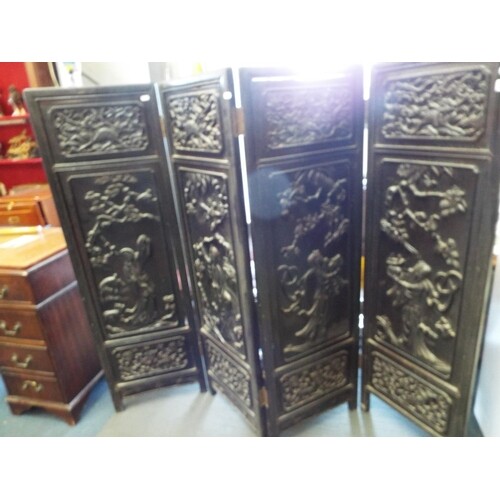A Chinese carved hardwood four fold screen decorated with Ga...