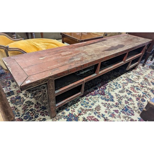 A Chinese red lacquer hardwood low altar table, width 240cm ...