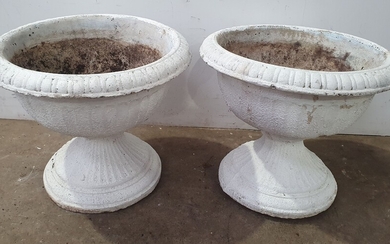 A PAIR OF FLUTED CONCRETE URN FORM PLANTERS