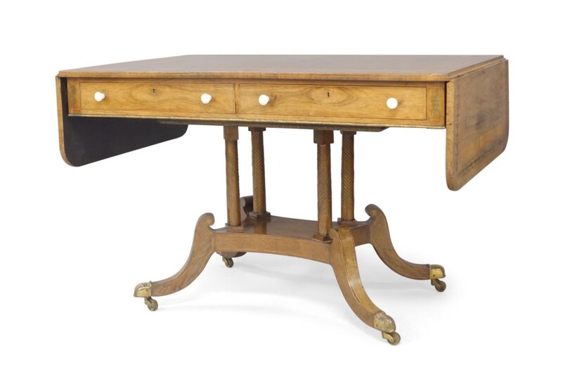 A Regency brass inlaid rosewood sofa table, satinwood crossbanding, two drawers to front and two faux drawers to back with turned ivory handles, raised on four cylindrical supports, four splayed legs to brass caps and castors, 72cm high, 166cm...