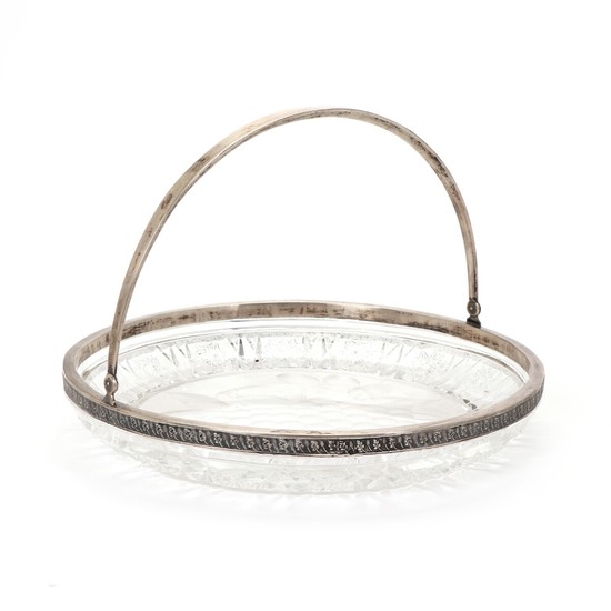 A Soviet silver-mounted svinghandle glass dish. Indistinct maker's mark. Silver fineness 875. Estonia 1924-c. 1939. Diam. 28.5 cm.