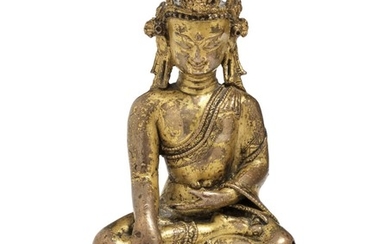 A Tibetan/Nepali gilt copper figure of the crowned Buddha. 14th-15th century. Weight 514 g. H. 13 cm.