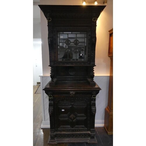 A Victorian Jacobean style carved oak upright Cabinet, with ...