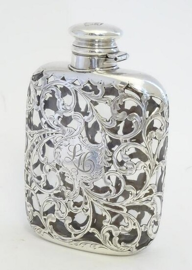 A Victorian hip flask, the glass flask with ornate
