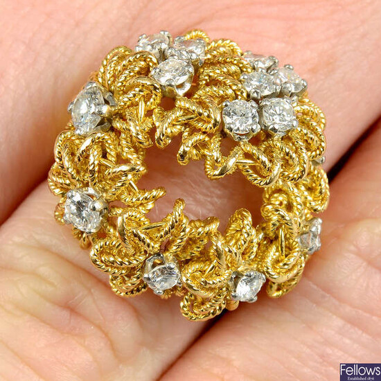 A brilliant-cut diamond and rope-twist floral wreath ring, with textured band.