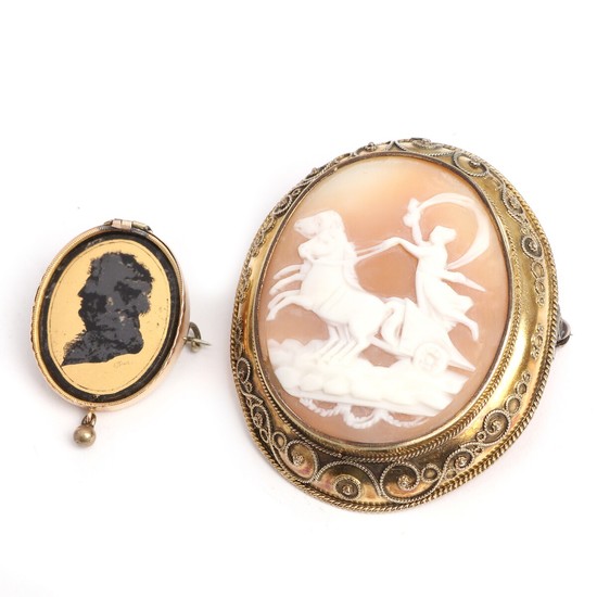 A cameo brooch set with a carved cameo, mounted in gilt metal and a 14k brooch with silhouette. L. 3–5.2 cm. (2)