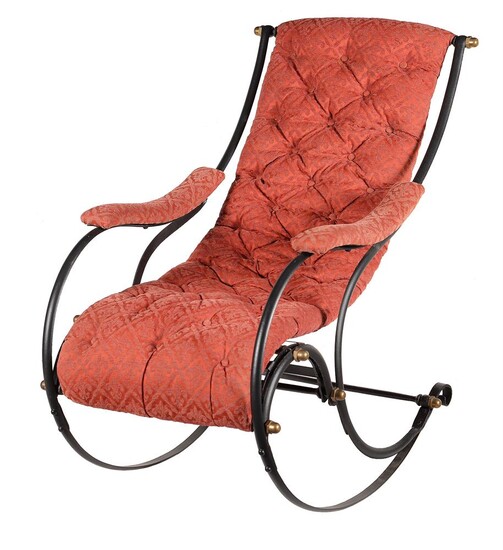 A cast iron and upholstered rocking armchair in Victorian style