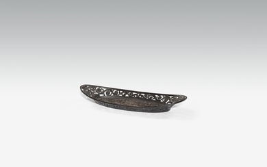 A cast iron wick trimmer plate with oak leaf relief