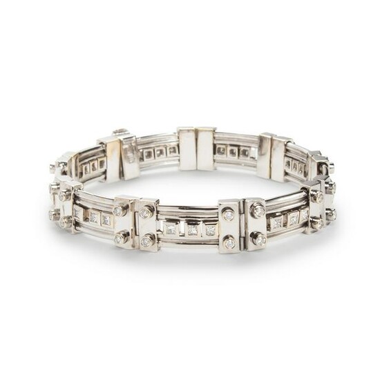 A diamond and eighteen karat white gold strap bracelet