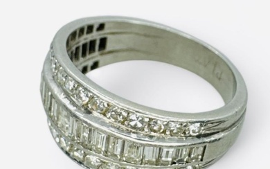 A diamond set dress ring, featuring three rows of diamonds....