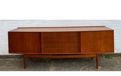 A mid century teak sideboard, fitted with four drawers flank...