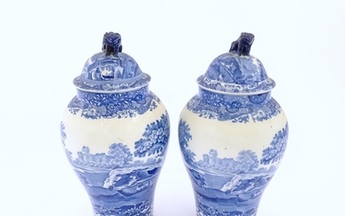 A pair of Copeland blue and white lidded vases decorated in ...