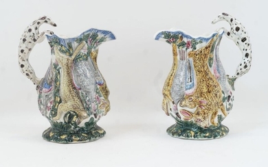 A pair of English pottery jugs, possibly Portobello, c.1830, each moulded in relief with a continuous frieze of game, the handles in the form of Dalmatians, the spouts marked John MARTIN, 30cm high (2)