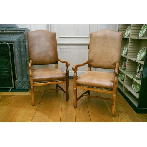A pair of French Regence style pine throne chairs with high ...