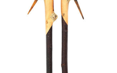A pair of carved sporting staffs by Ian Jones
