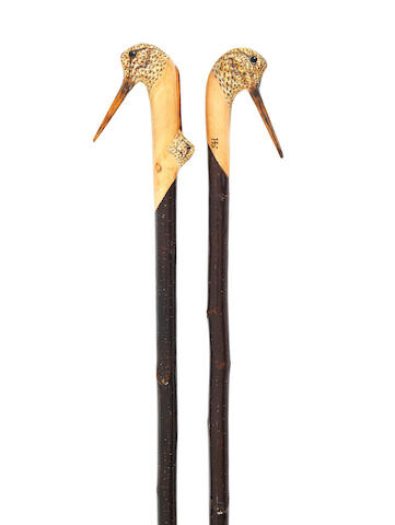 A pair of carved sporting staffs by Ian Jones