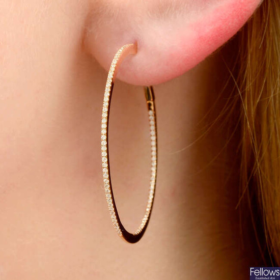 A pair of front-facing brilliant-cut diamond hoop earrings.
