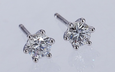 A pair of solitaire earrings in 18 kt. white gold, total 0.68 ct. (F-G/SI-P) (2)