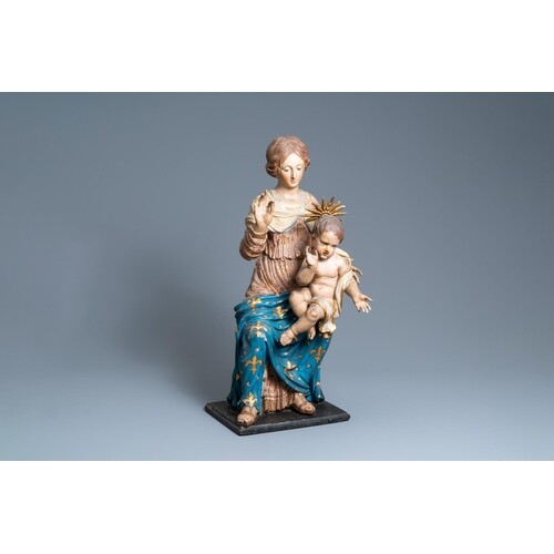 A polychromed wooden figure of a Madonna with child, 17th C....