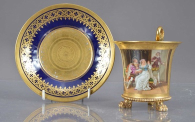 A porcelain chocolate cup and saucer with gilt and enamel decoration