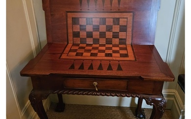 A reproduction Mahogany foldover Games Table with single fri...