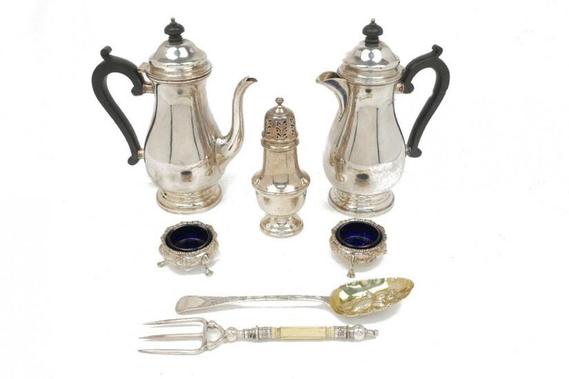 A silver coffee pot and a silver...