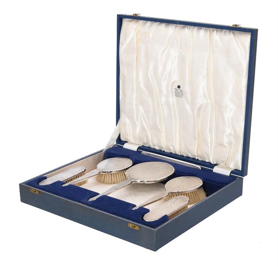 A silver six piece dressing table set
