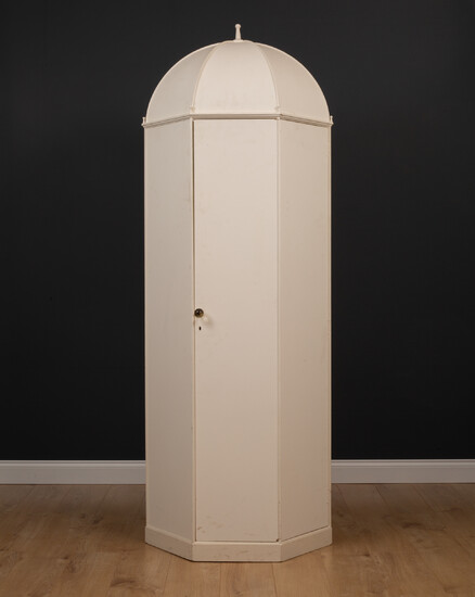 A small octagonal white painted wardrobe
