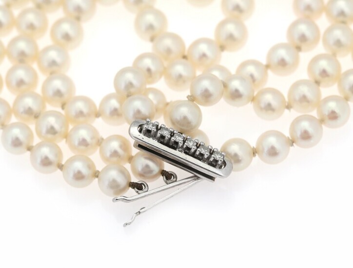 NOT SOLD. A three-string pearl bracelet set with cultured pearls and clasp set with numerous...