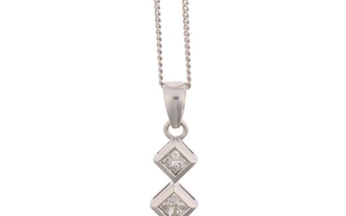 An 18ct white gold three stone diamond drop pendant, set wit...