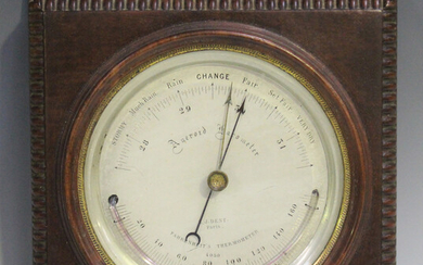 An Edwardian mahogany cased aneroid wall barometer, the silvered circular dial with alcohol thermome