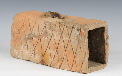 An ancient Roman terracotta flue brick with incised crosshatching to two sides, length 35cm.