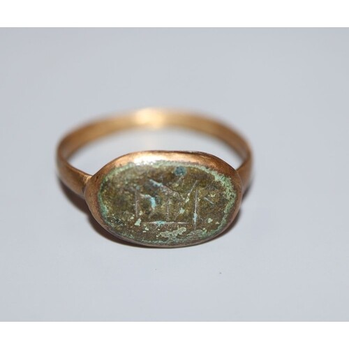 An antique gilt metal and oval bronze plaque set ring, size ...