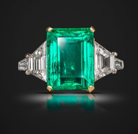 An emerald and diamond ring, the emerald-cut emerald weighs 5.03cts,...
