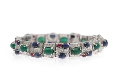 NOT SOLD. An emerald, sapphire and diamond bracelet set with numerous diamonds and numerous emeralds,...