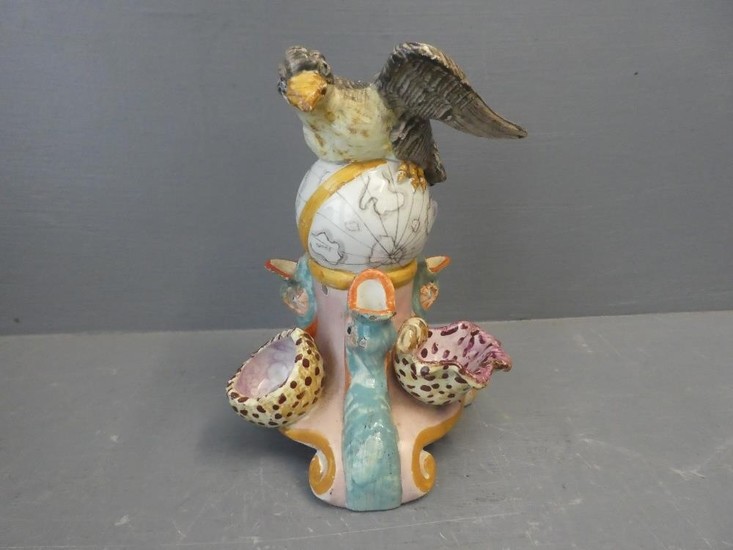 An ornate vase with a sea eagle on a globe 15H x 13W cm