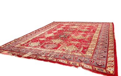 Antique Heriz style carpet, with angular medallions on brick red ground, in meander borders, approximately 380 x 470cm