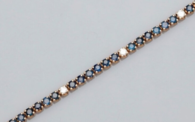 Beautiful line bracelet in yellow gold, 750 MM, highlighted with round sapphires, beautiful color, interspersed with six diamonds totaling about 0.60 carat, length 17.80 cm, weight: 15.6gr. rough.