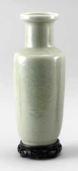 CHINESE CELADON PORCELAIN VASE In baluster form, with lightly incised peony decoration. Height 11.25". With wood stand. Provenance:...