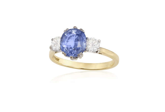 Description A SAPPHIRE AND DIAMOND RING The oval-shaped sapphire...