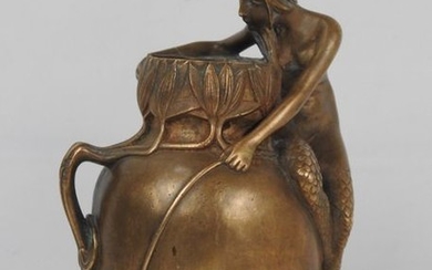 Hollow bronze vase with golden patina representing a...