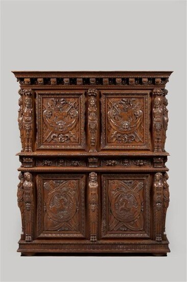 In the taste of Hugues SAMBIN (1520-1601), a beautiful two-body rectangular buffet, in moulded walnut with richly carved scultpure, opening on the front with two leaves and two drawers in the lower part, and two leaves in the upper part. The jambs are...