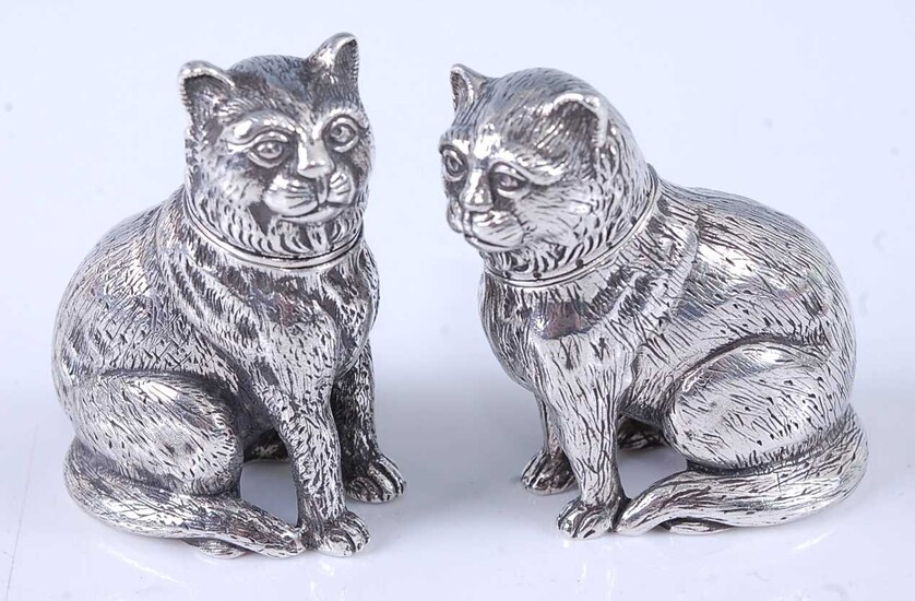 A pair of cast silver novelty pepperettes