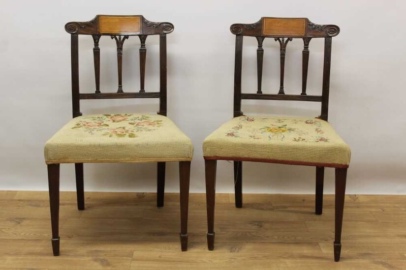 Pair of late 18th century Sheraton inlaid mahogany dining chairs, with shaped scroll top rail above reeded pilasters, needlework seats and square taper legs with spade feet