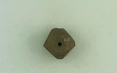 Rough faceted and drilled diamond of 15 cts approx.