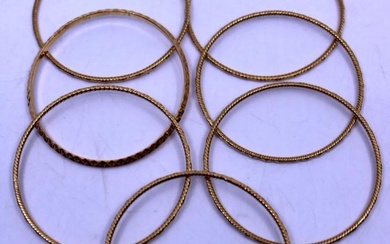 Selection of Seven Unmarked Yellow Metal Patterned Bangles. Total weight...