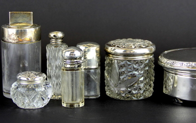 Seven hallmarked silver and cut glass perfume bottles together with a small hallmarked silver powder box.